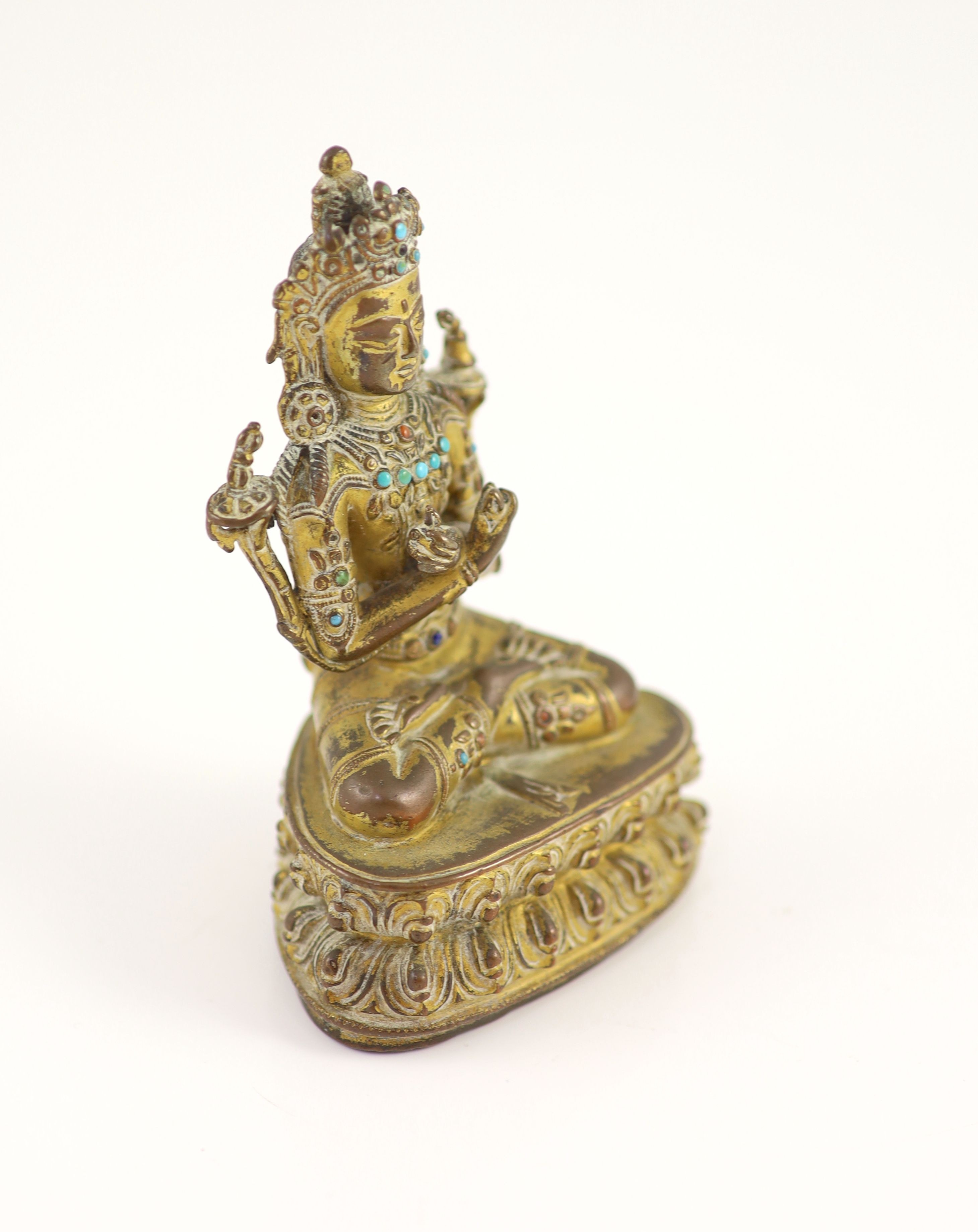 A Tibetan gilt copper alloy seated figure of Maitreya, possibly 15th century, 11.5 cm high